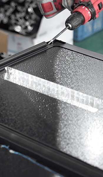 Close-up of a mounting point being fastened on a black exterior component