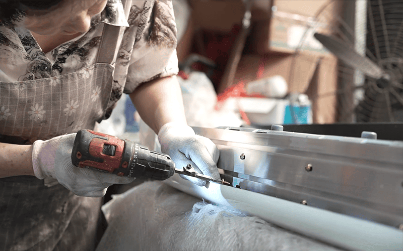 Worker manufacturing an automotive exterior component