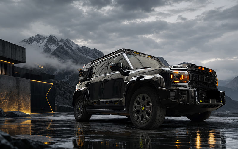 Off-road body kit application on a black SUV in a mountain setting