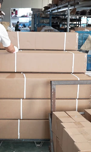 Automotive exterior parts cartons secured in a factory packing area