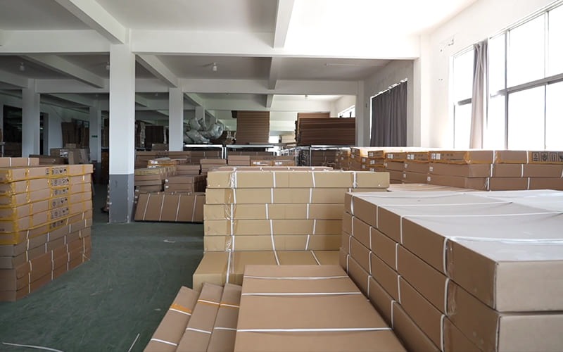 Cartons of automotive exterior parts arranged in a factory packing area
