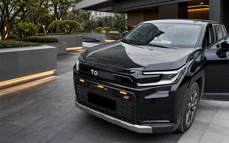 Three-quarter front view of a black SUV showing its grille and surrounding bodywork