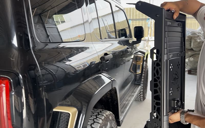 Black SUV body and side ladder shown together for mounting-area review