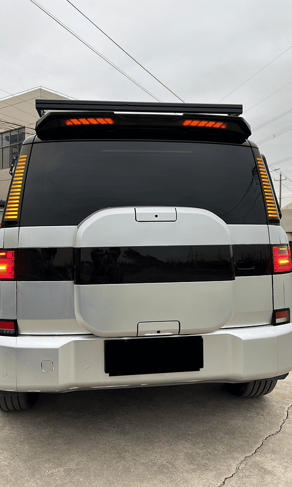 Rear view of a white SUV fitted with a roof spoiler